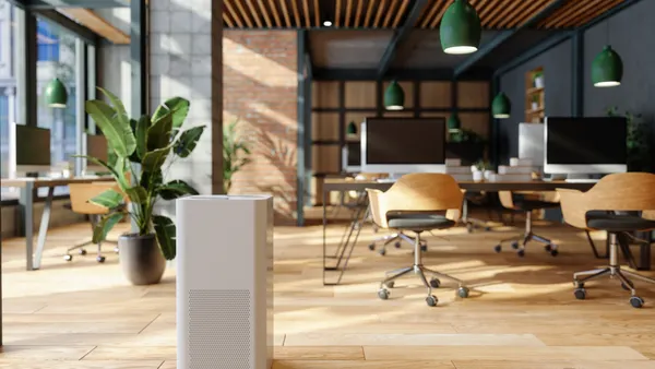 An air purifier in a modern, open plan office.