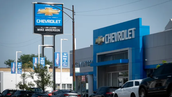A sign at the entrance of a GM dealership on July 22, 2025 in Chicago, Illinois