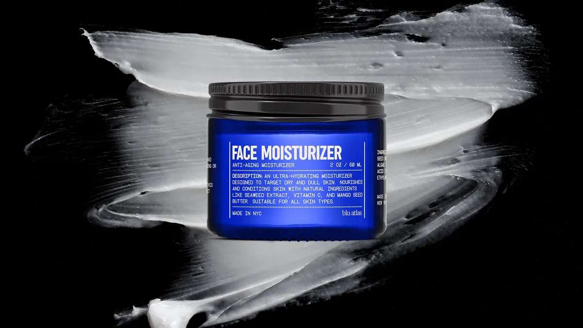 A blue moisturizer jar with a black backdrop