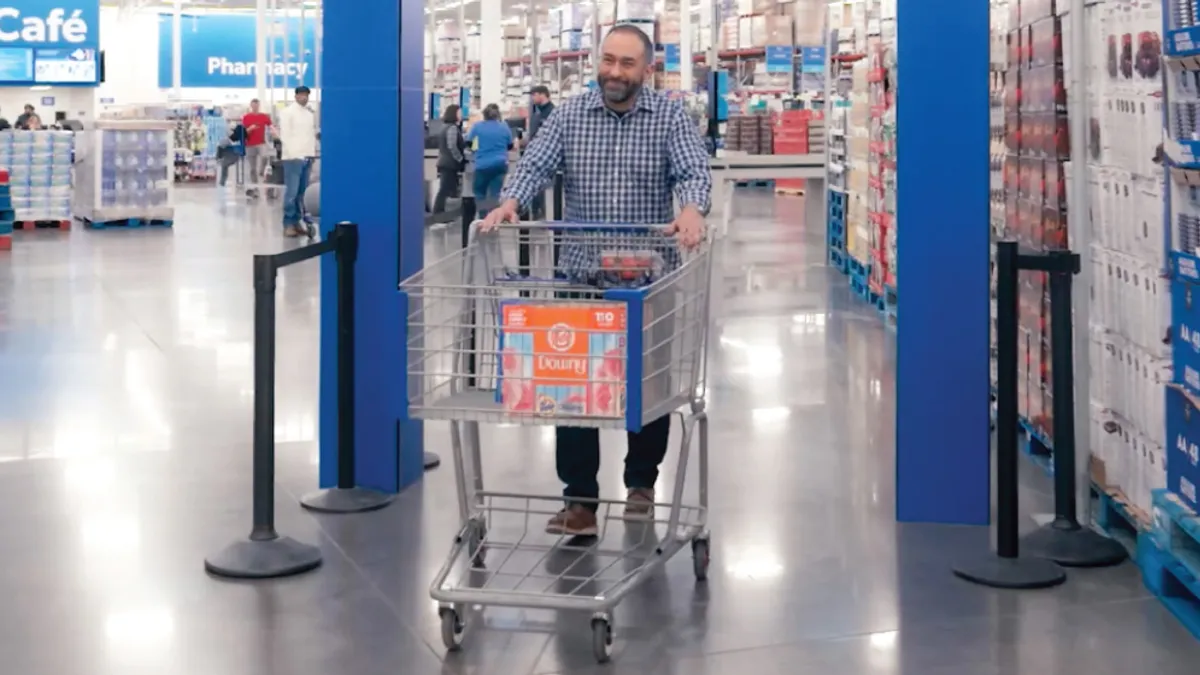 A customer walks through automated receipt verification at Sam's Club