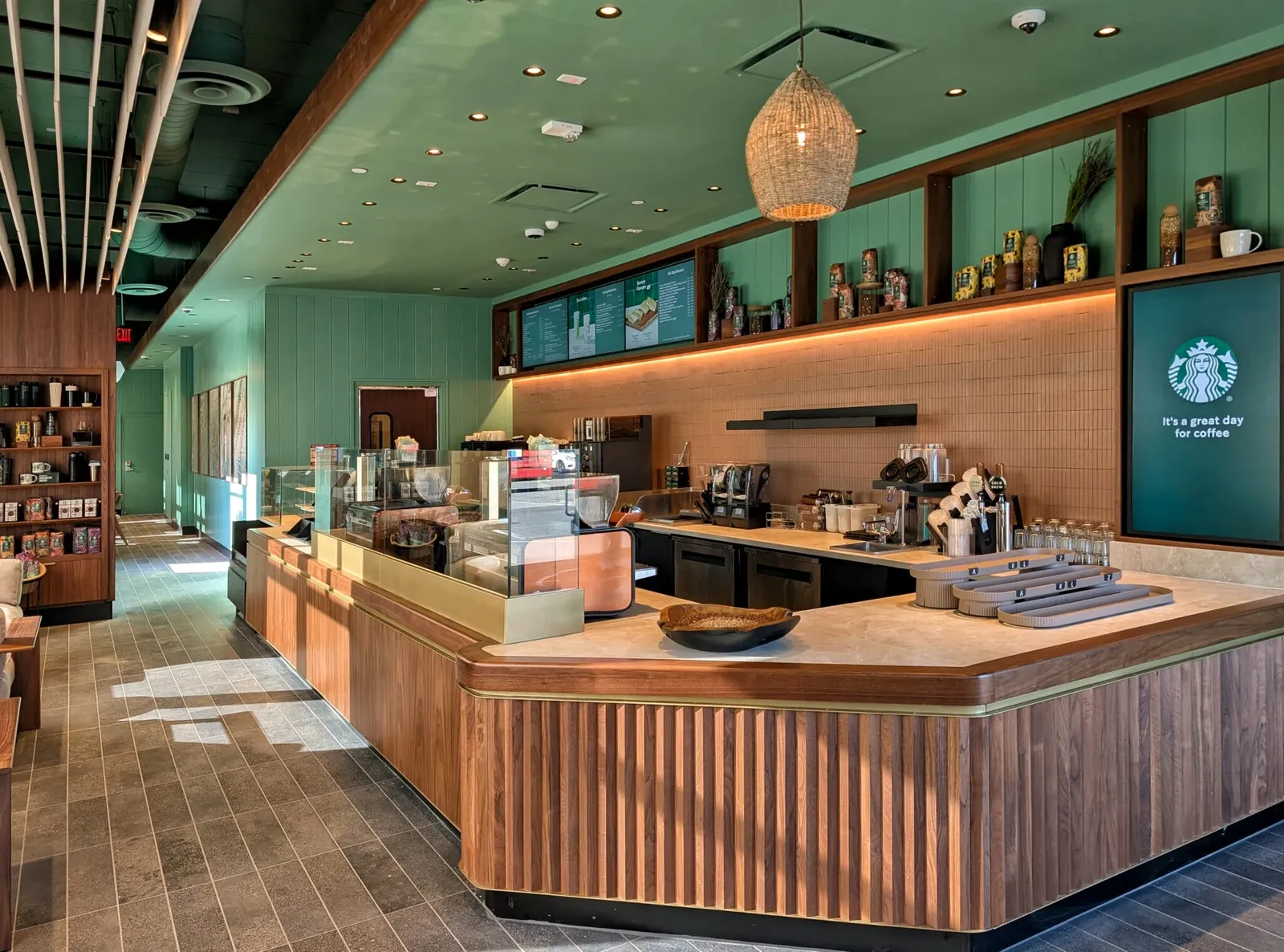 An empty Starbucks redesigned with lots of green and open space.