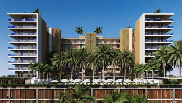 High-rise apartment project with palm trees in the foreground.