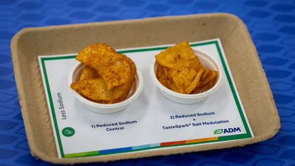 Two plastic mini bowls contain barbecue potato chips.