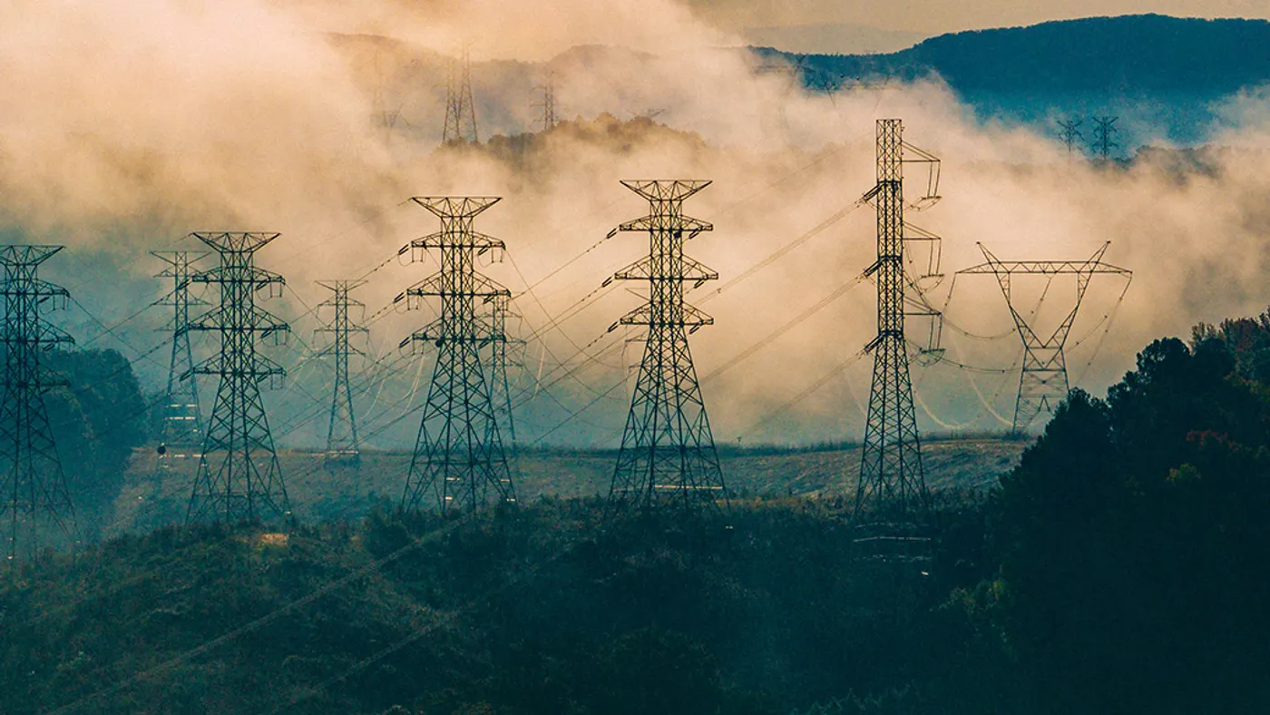 Grid towers with fog in the background