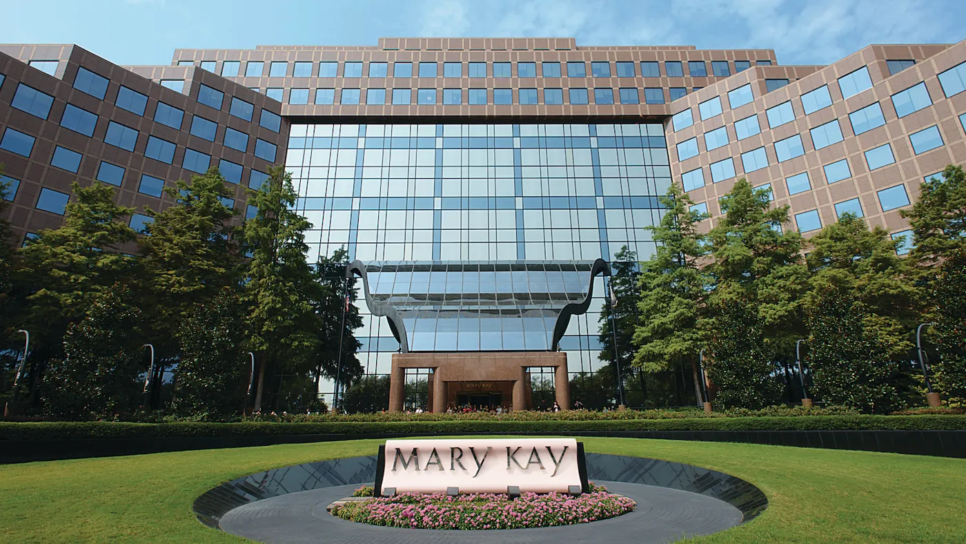 an exterior shot of a corporate campus, bearing Mary Kay's logo at the bottom