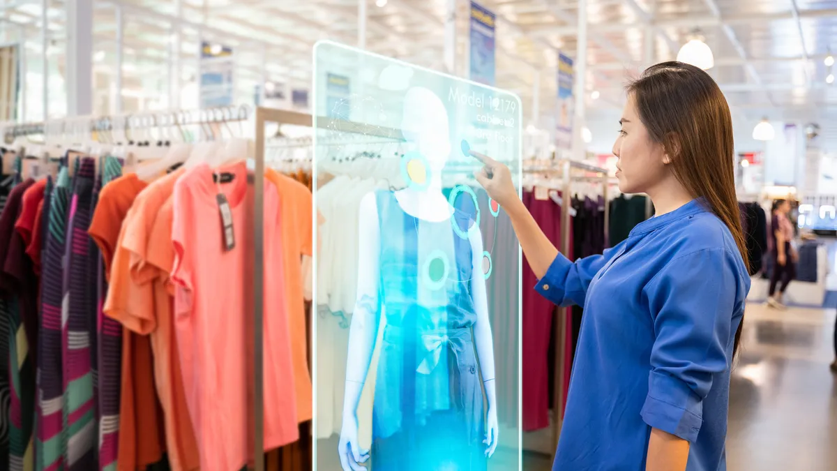 futuristic technology concept.happy girl tries to use smart hologram display with virtual augmented reality in the shop or retail to choose select ,buy clothes and change a color of products.