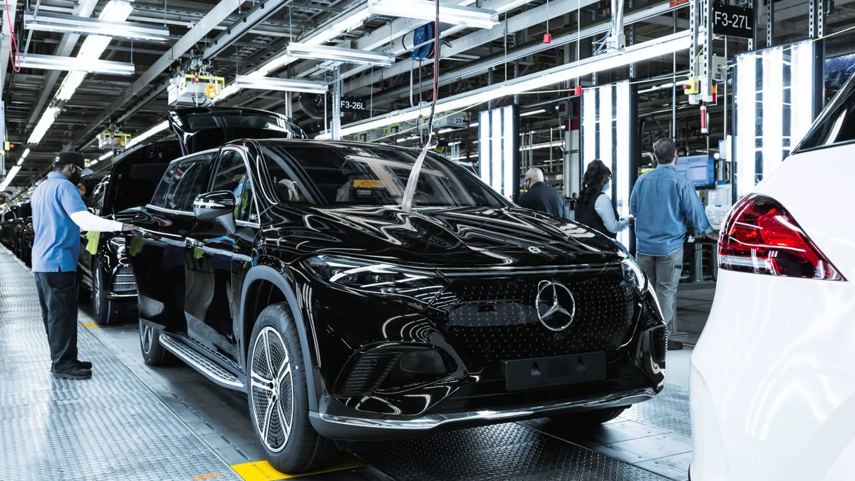 Mercedes-Benz workers assemble the EQS SUV