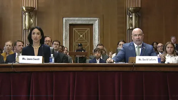 Two people sit at a table.
