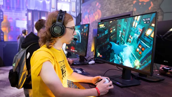 A gamer plays the video game LEGO Batman: Legacy of the Dark Knight during the Gamescom 2025 computer gaming fair.