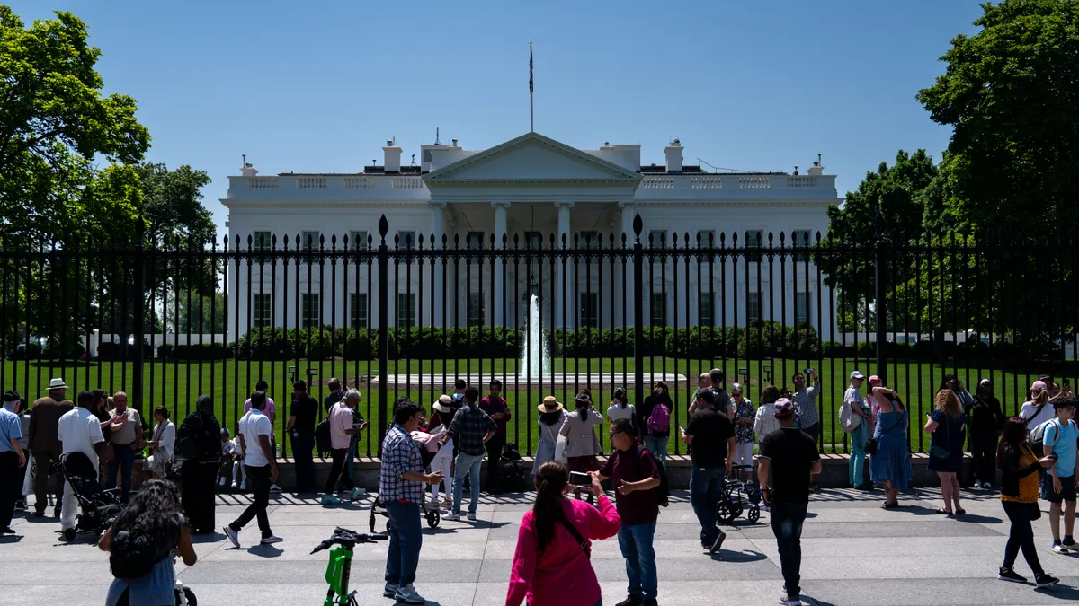 People enjoy the warm weather outside the White House on April 28, 2024 in Washington, DC.