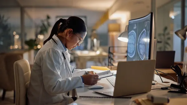Computer, reading and doctor asian woman in hospital at night for healthcare