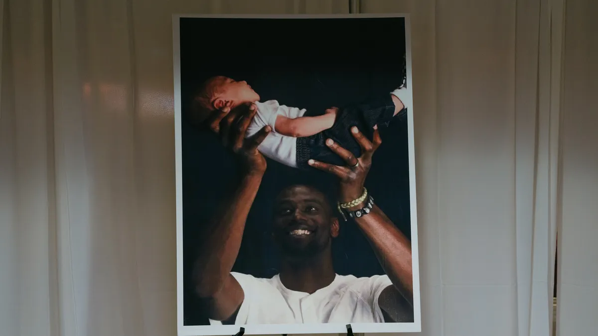 A print of Tyre Nichols holding his child is displayed in the church where his funeral was held