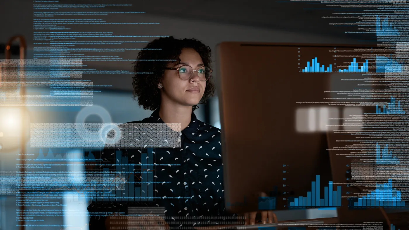 Shot of a programmer working on a computer code at night