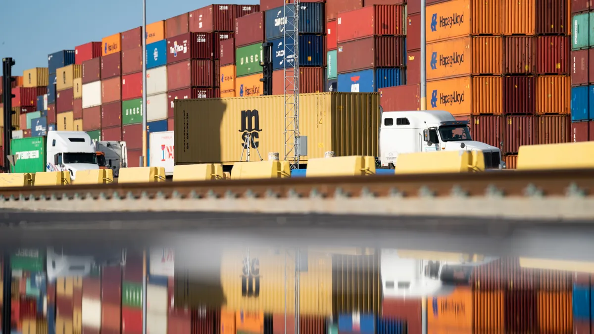 Trucks pass stacks of empty containers at the Garden City Port Terminal on November 12, 2021 in Garden City, Georgia.