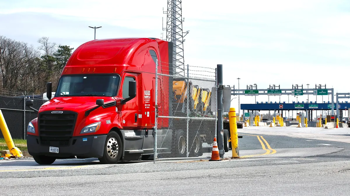 A Truck exits from the Baltimore Port after the cargo ship Dali ran into and collapsed the Francis Scott Key Bridge on March 26, 2024 in Baltimore, Maryland.