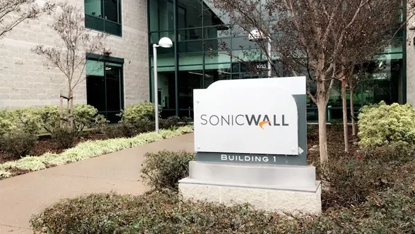 A sign in front of a modern office building with the SonicWall logo on it.