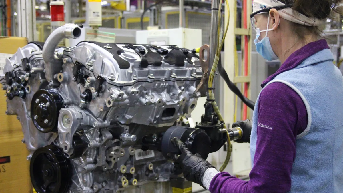 An autoworker assembling an engine at General Motors' St. Catharines Propulsion Plant in St. Catharines, Ontario, Canada.