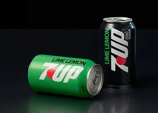 A green can of 7Up soda lays on its side next to a black can of 7Up.