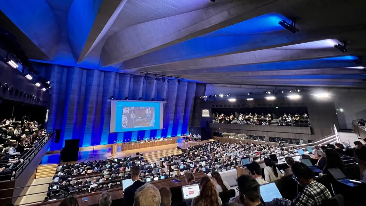 Attendees sit in the UNESCO Headquarters in Paris to listen to plastic treaty talks.