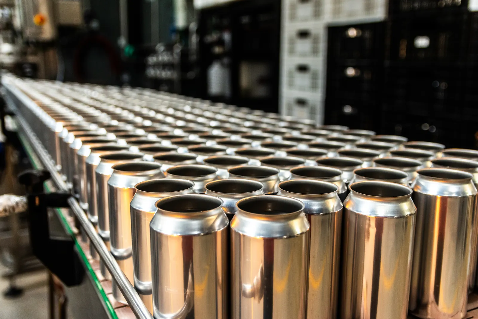 Rows of metal cans on a manufacturing line.
