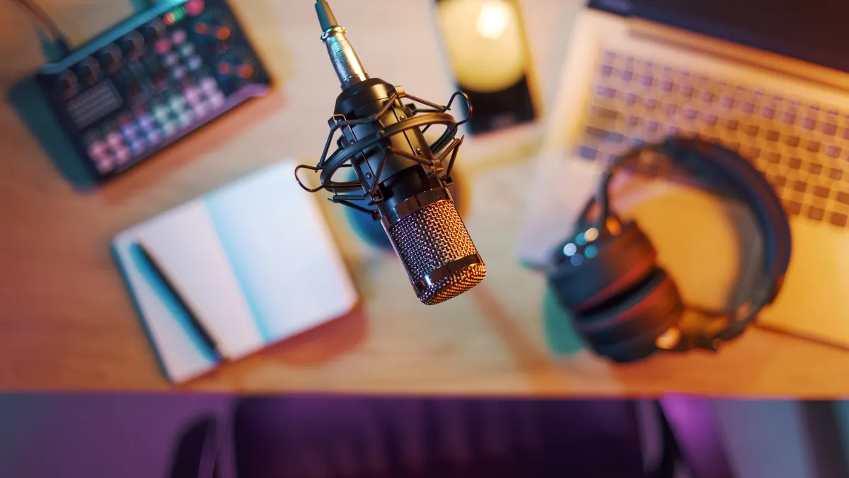 Professional audio equipment, notebook, laptop and smartphone on the desk in the home studio.