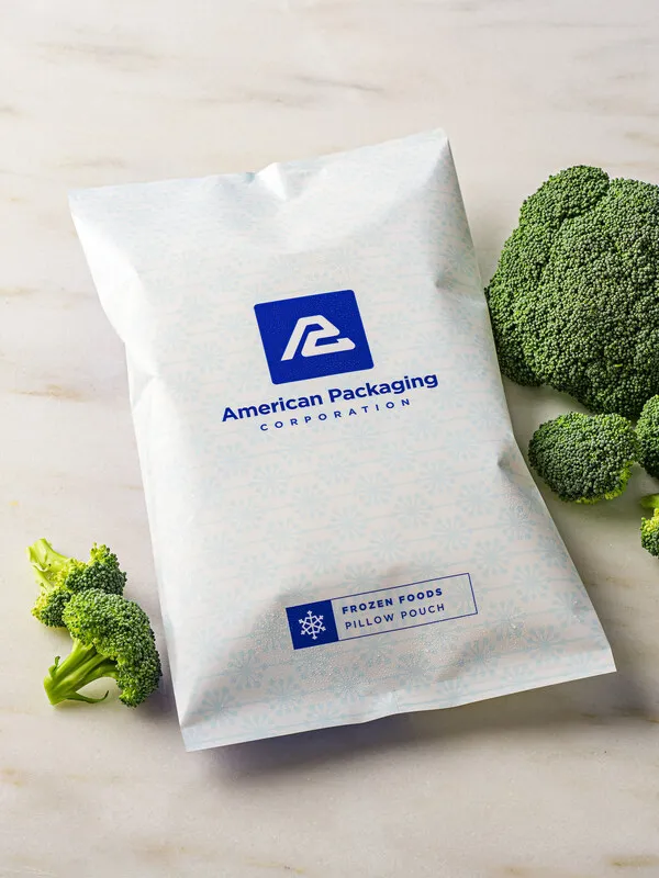 A white flexible plastic frozen food pouch with blue American Packaging Corp. branding.