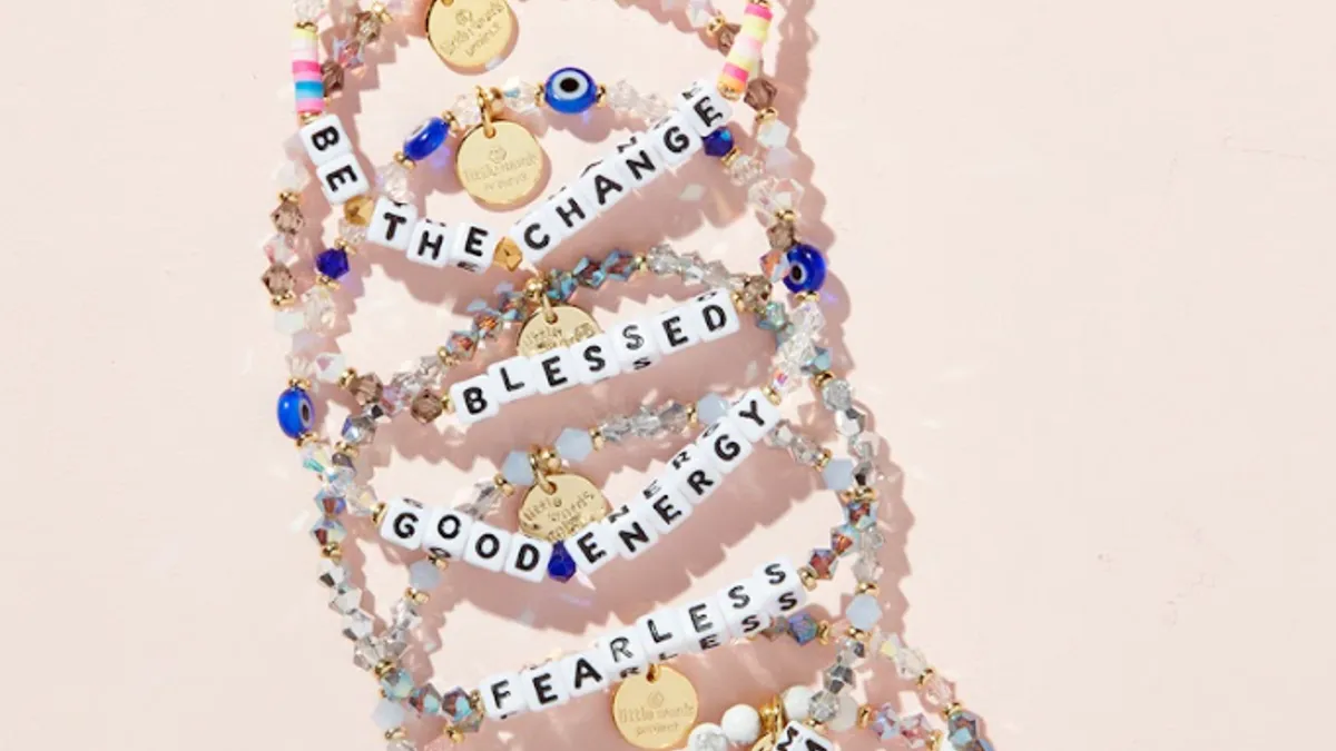 A stack of Little Words Project's beaded bracelets.