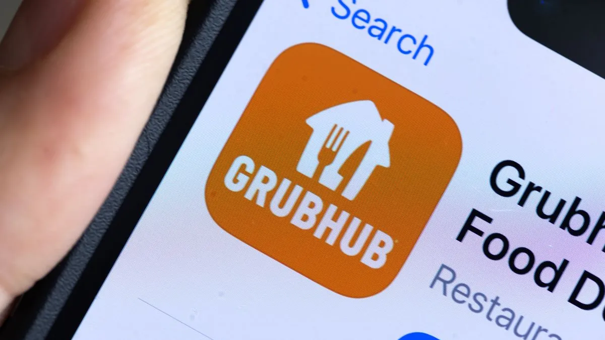 A zoomed in image of a smartphone with a on orange app square that says "Grubhub" in white.