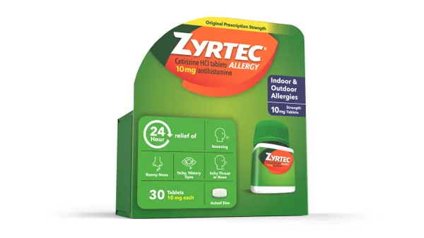 A green box of Zyrtec allergy medication with orange messaging.