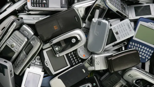 A pile of older cell phone devices