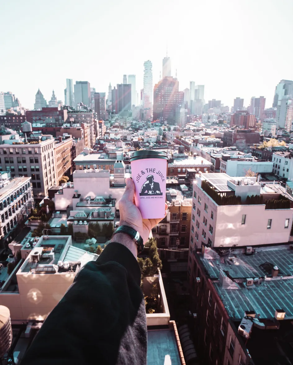 A hand holding a Joe &amp;amp; the Juice cup