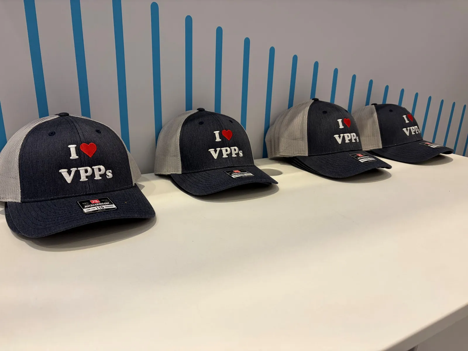 A row of caps that say "I [heart] VPPs"