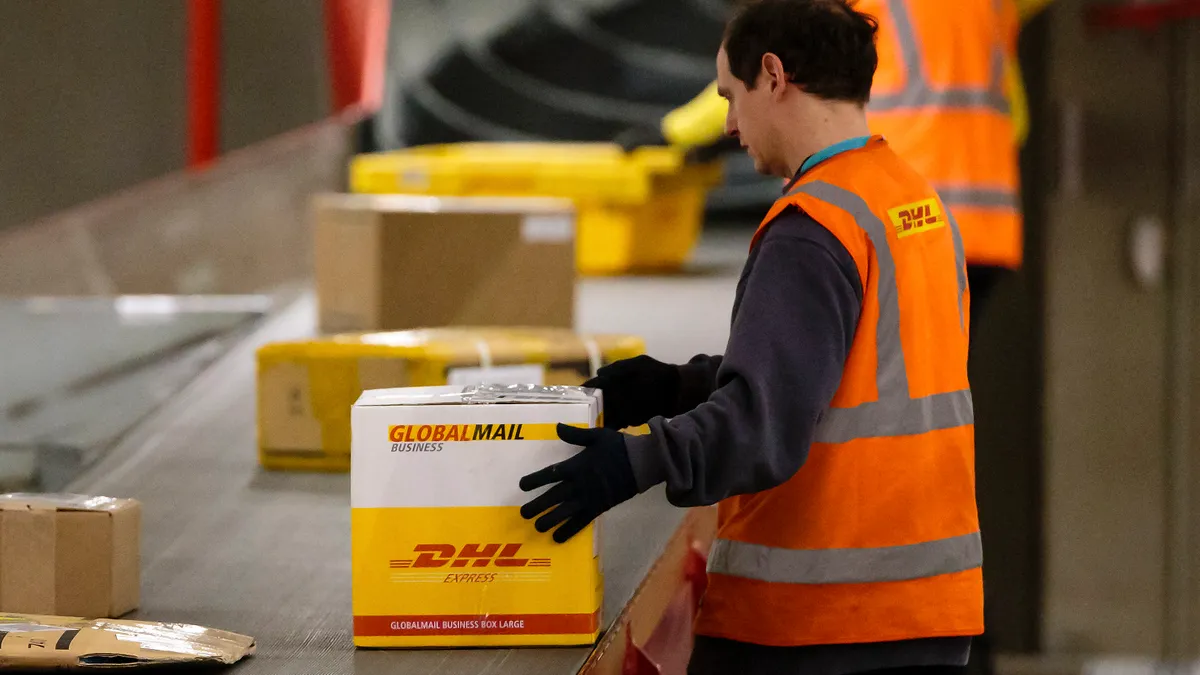 A worker sorts parcels during the night at the DHL hub on February 27, 2014 in Leipzig, Germany.