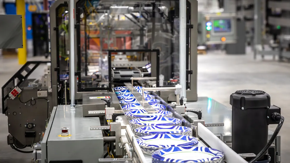 A manufacturing line with paper-based table ware coming off the conveyor.