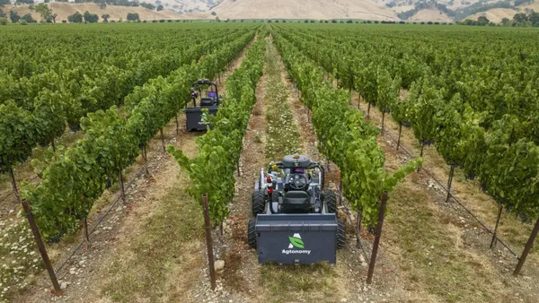 Tractors with the Agtonomy logo are seen in wine vineyards