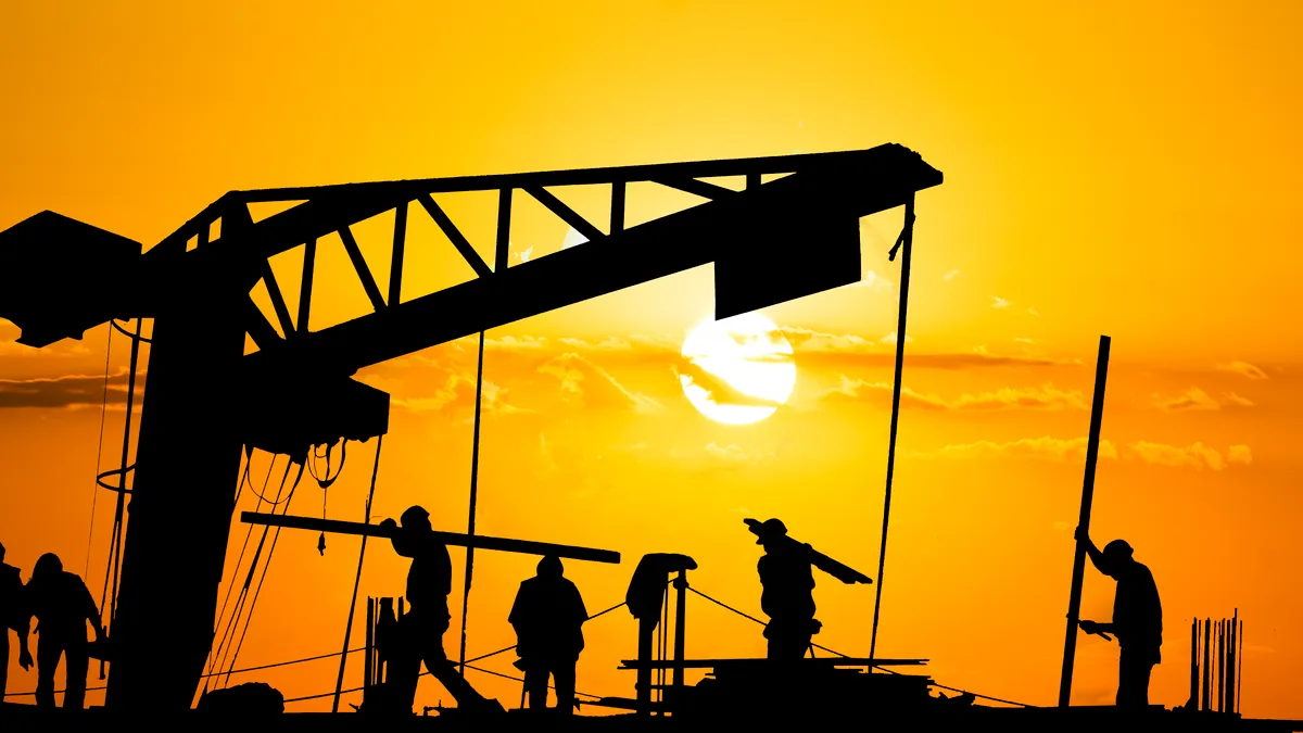 A silhouetted shot shows construction workers laboring in hot conditions.