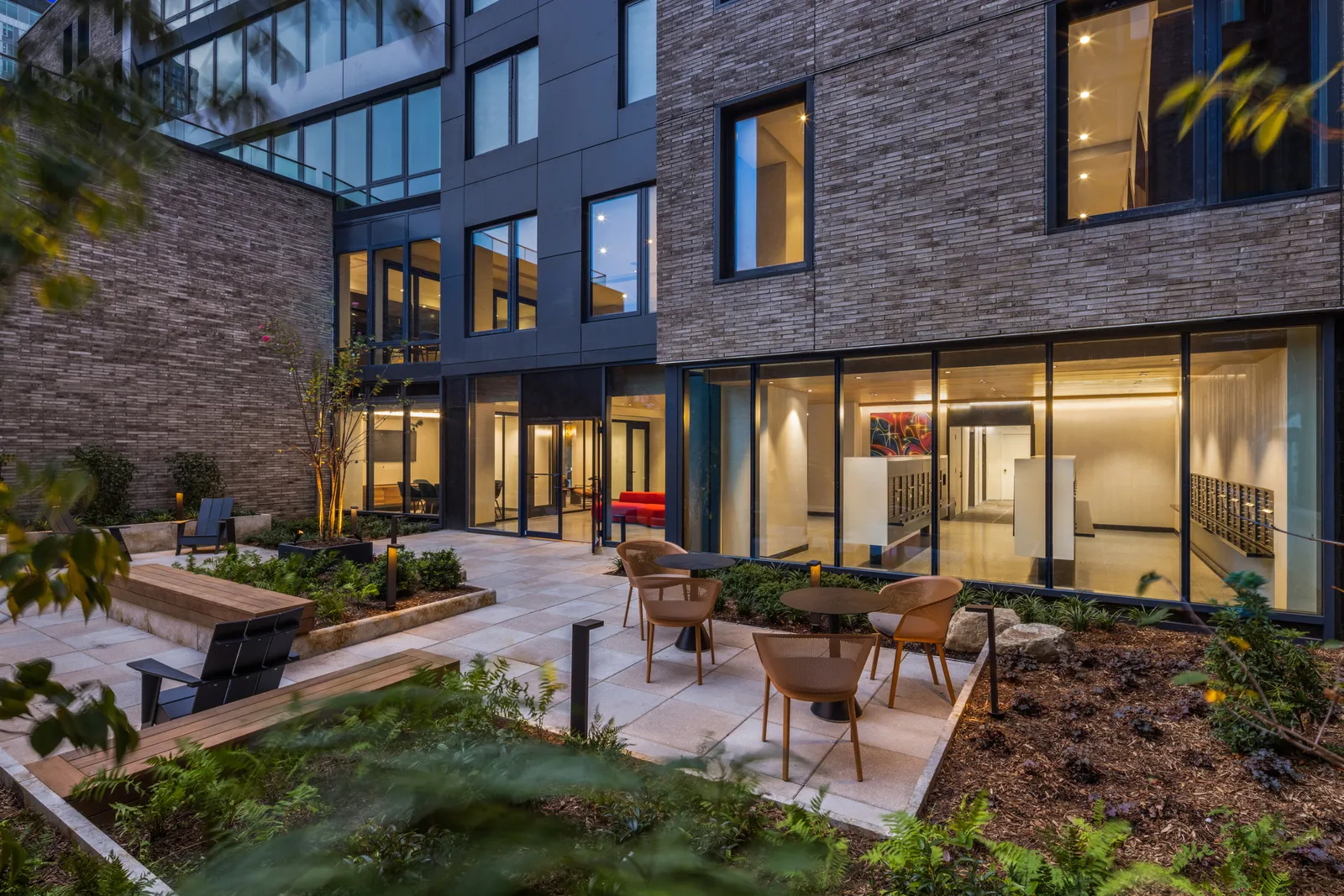 An outdoor space next to a building with chairs.