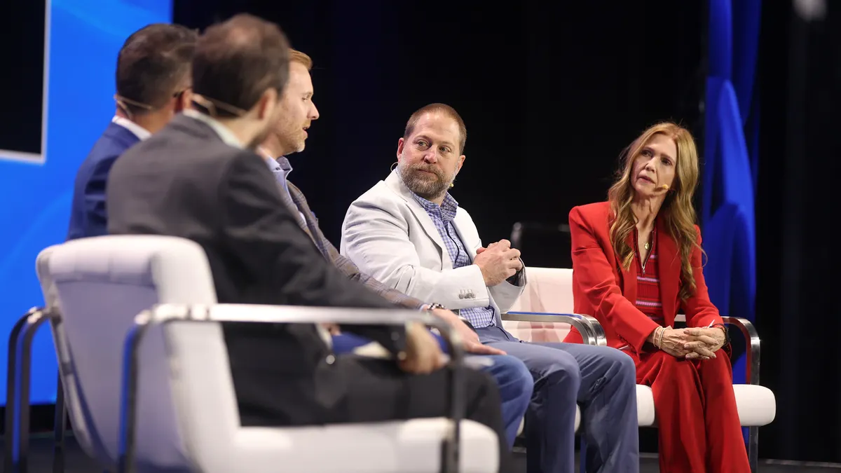 people on stage in a panel