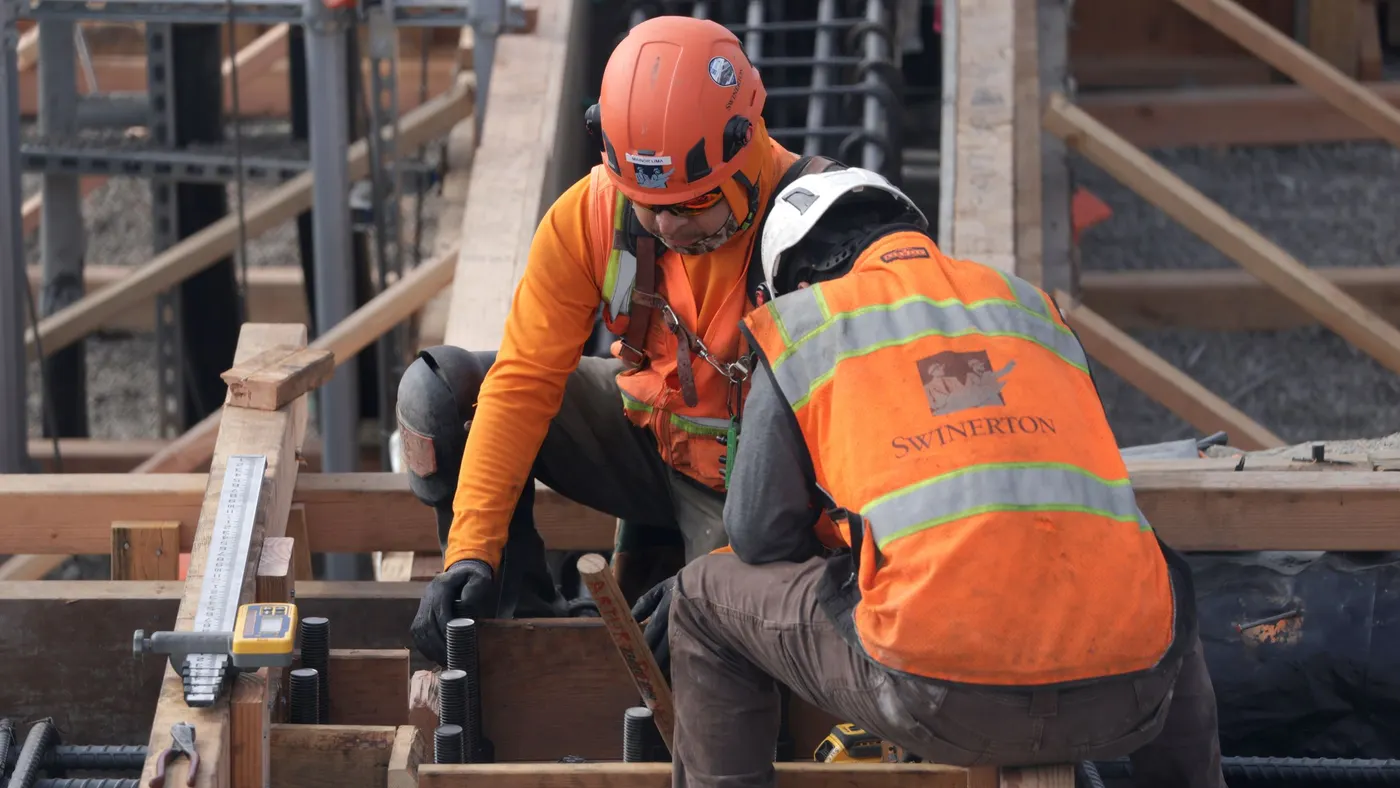 Construction workers build out a new building.