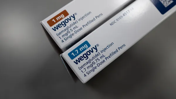 Two prescription drug cartons are seen standing vertically on end, bearing the word Wegovy.