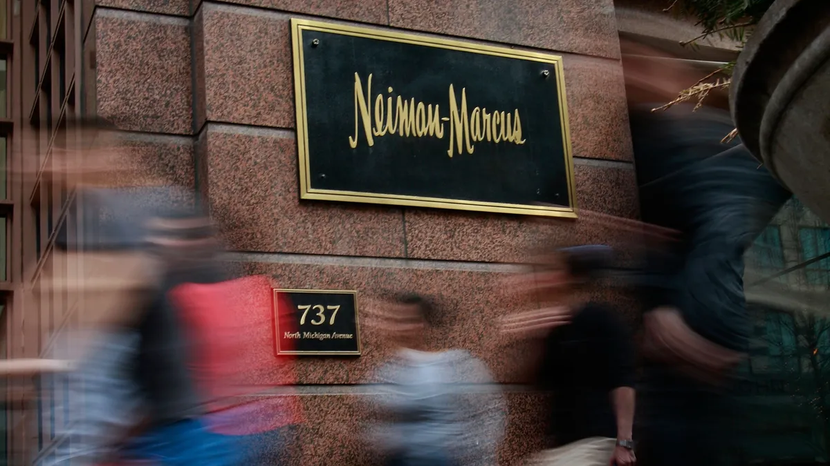 Pedestrians walk past a Neiman Marcus store.