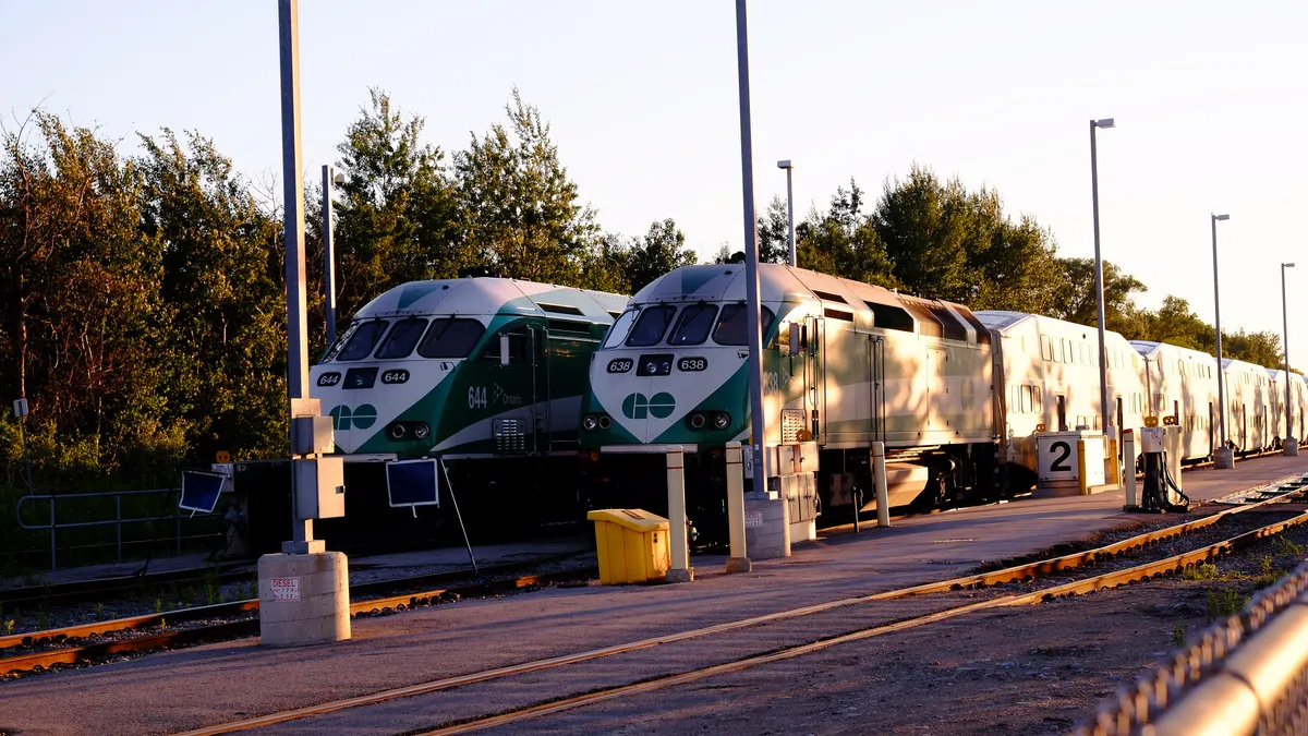 Two green Ontario GO trains.