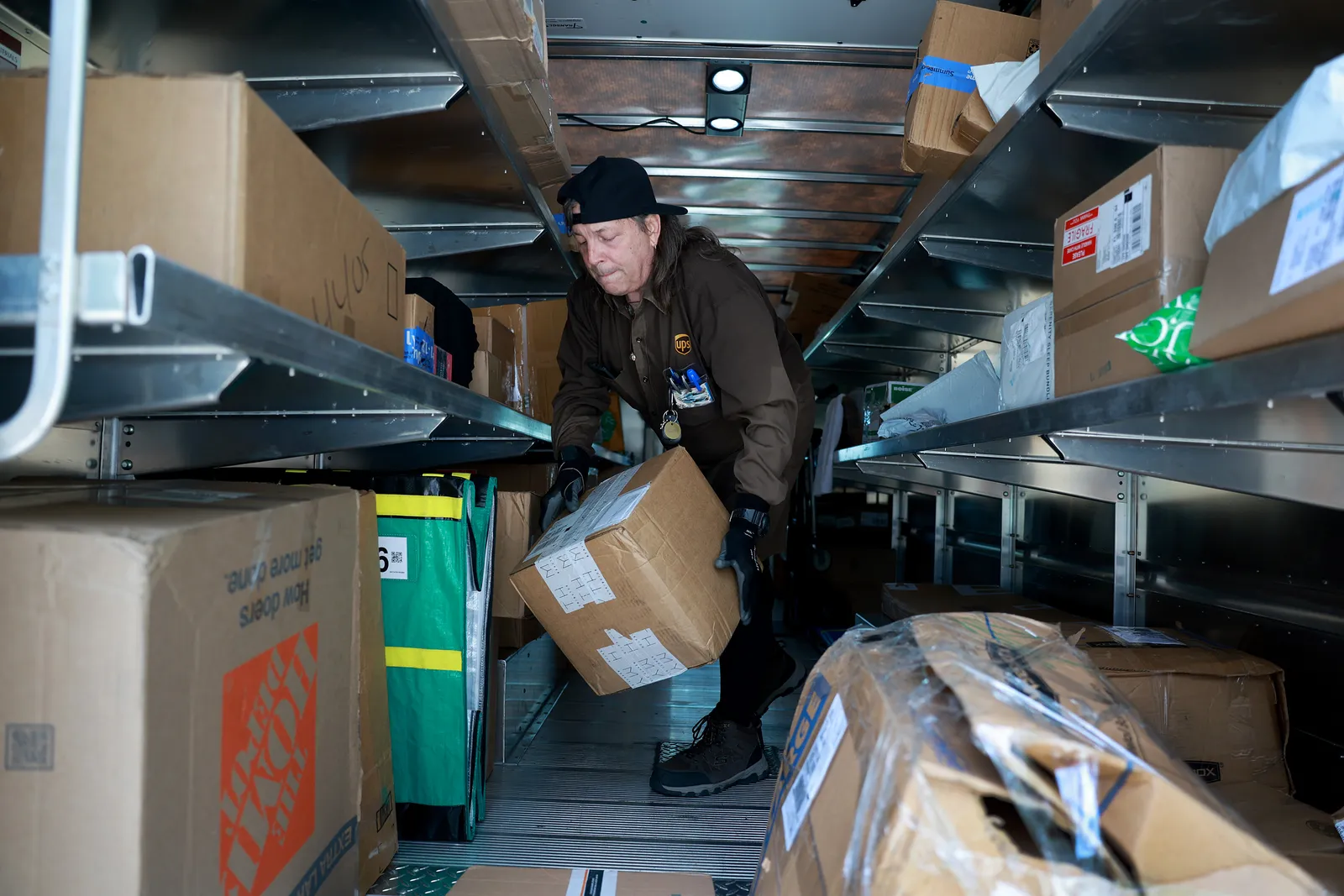 A UPS driver makes a delivery on June 30, 2023 in Miami, Florida.