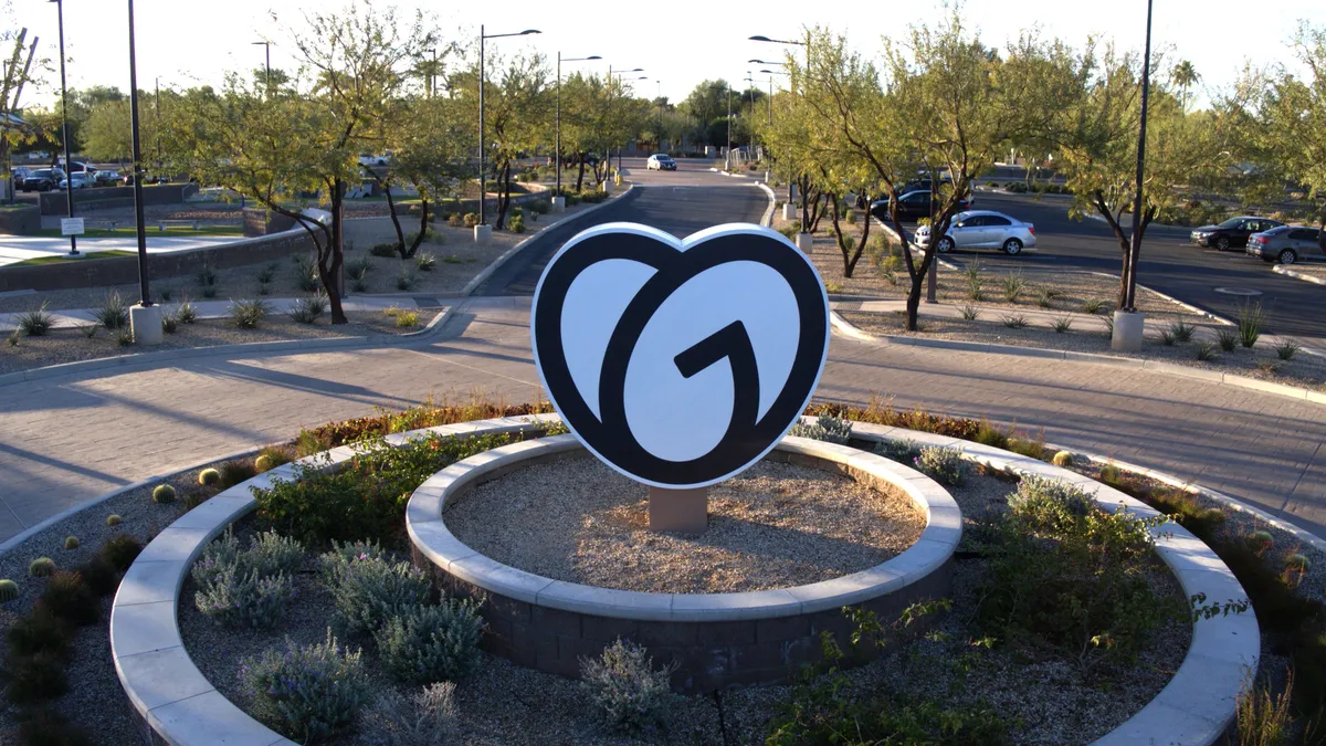 A photo of the GoDaddy logo sculpture in front of the office in Tempe, AZ