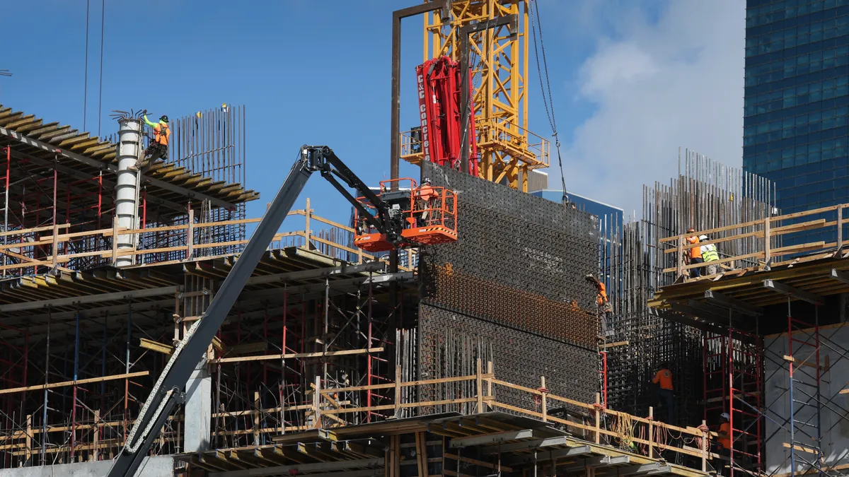 Construction workers help build a condo tower