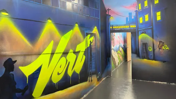 A colorfully painted wall inside a facility with branding for Vert.