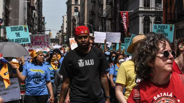 A Black man stands front and center at an Amazon Labor Union protest
