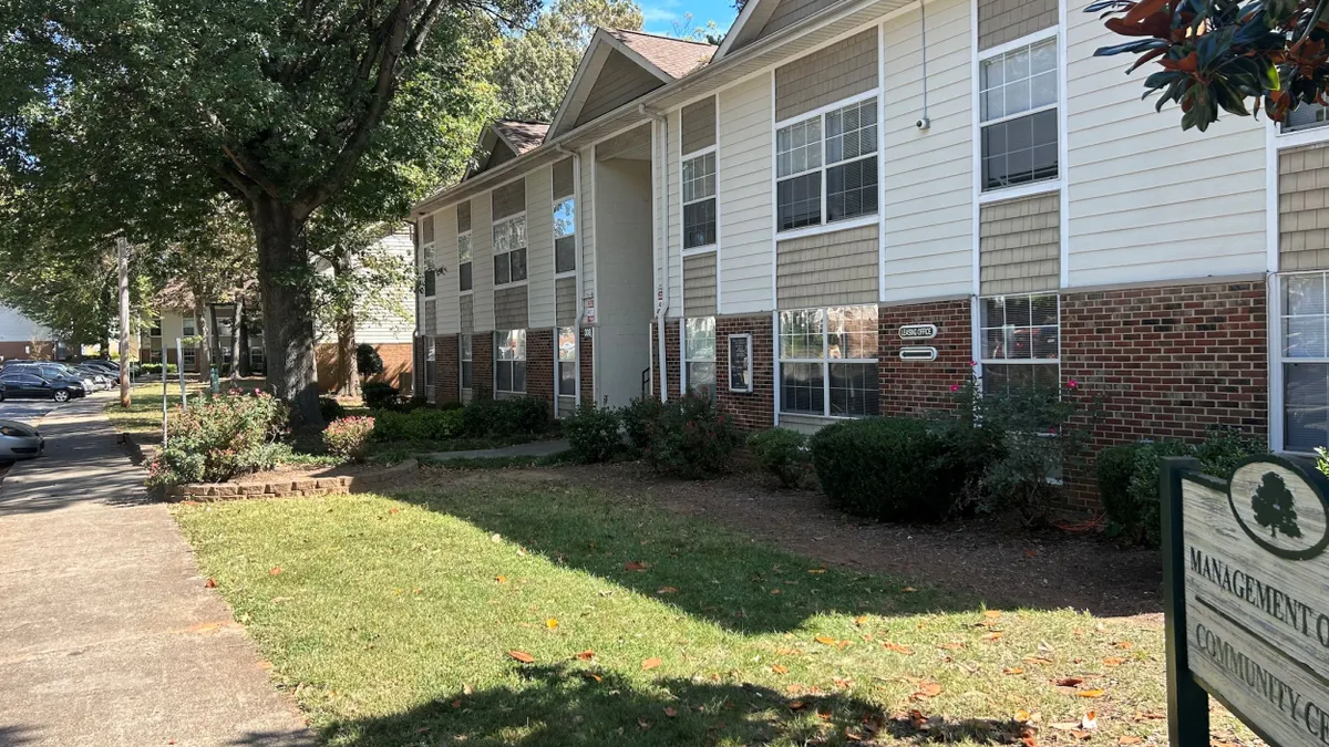 Tan and brick garden apartment property.