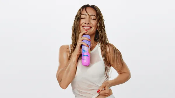 Hilary Duff holding Bath & Body Works products.