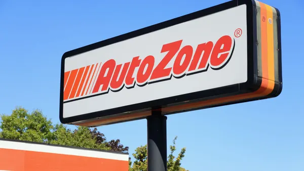 An AutoZone sign against a blue sky